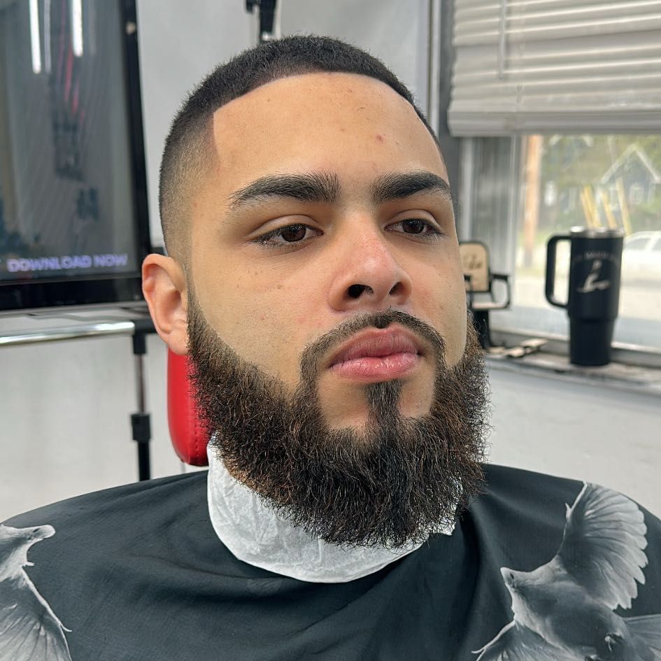 Client with a fresh skin fade and sculpted beard at The Luxe